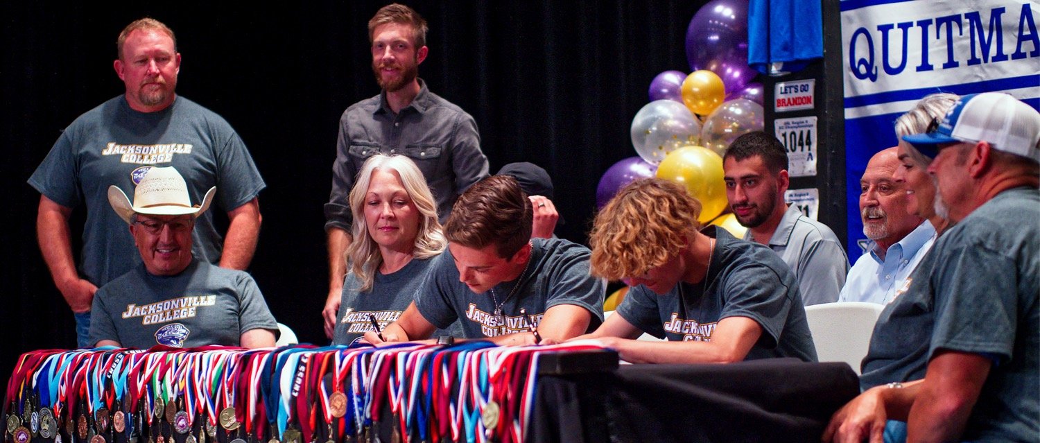 Brandon Jimenez and Jack Tannebaum of Quitman sign letters to compete in track at Jacksonville College. [see more signing celebrations]
